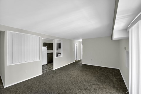 a living room with carpet and white walls